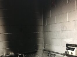 A fire in a bathroom with a toilet and a sink.
