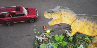 dinosaur looking at car