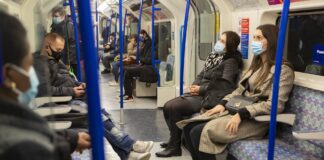 People on public transportation wearing masks
