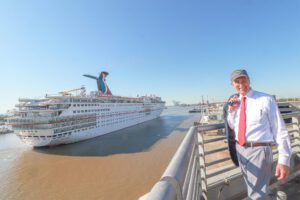 Mayor Stimpson standing next to Carnival ship
