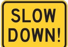 SLOW DOWN sign
