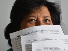 woman holding income tax return forms