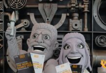 mascots resembling statues holding World Games tickets