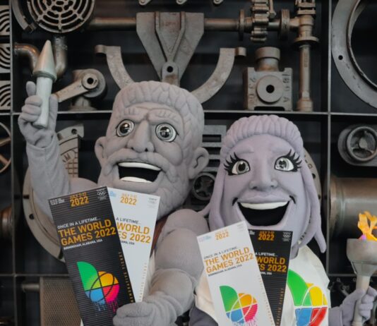 mascots resembling statues holding World Games tickets