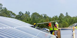 working men installing solar panels