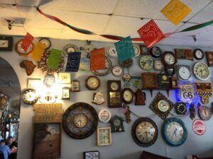 clock collection on wall and Mexican dorations