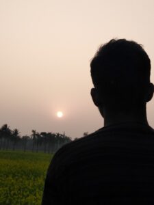 Silhouette of person looking toward the sun
