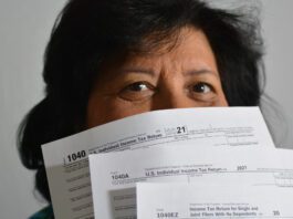 person holding tax return forms