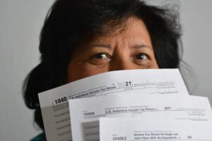 person holding tax return forms