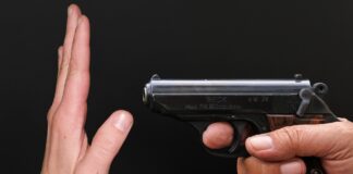 hand in front of a gun