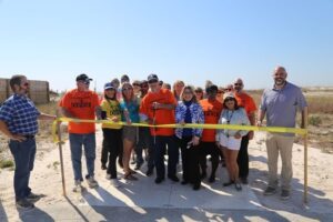 Commissioner Bergosh is joined by supporters of Beach Access #4 as he cuts the ceremonial ribbon