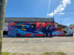 Mural of Blue Angels on store wall by Patrick Quintanilla