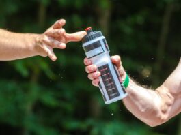 hands sharing a water bottle