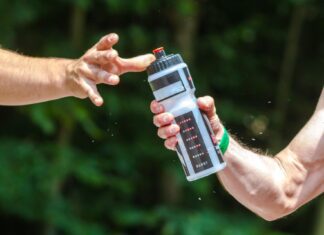 hands sharing a water bottle