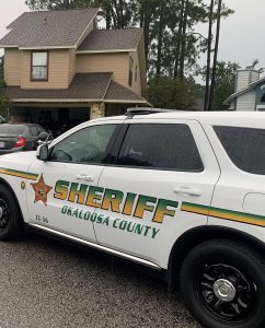 Okaloosa County Sheriff's vehicle in front of a home