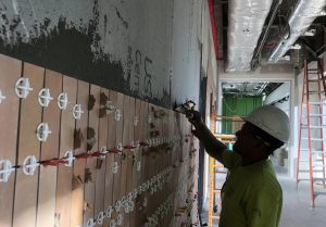 Worker installing tile at the new Baptist Hospita;