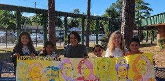 Student display their artwork of influential Hispanic Americans