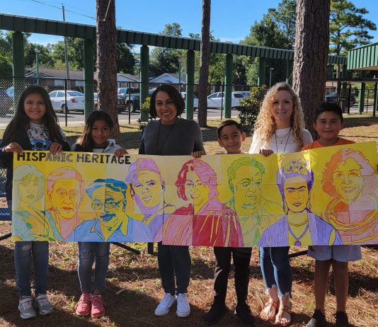 Student display their artwork of influential Hispanic Americans
