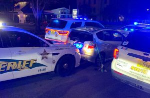Sheriff's deputies surround a vehicle