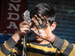 Child holding a wrench