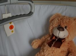 Teddy bear on hospital bed