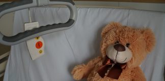 Teddy bear on hospital bed