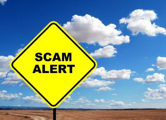 Caution sign that reads "Scam Alert"
