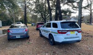 home with sheriff's vehicles in driveway
