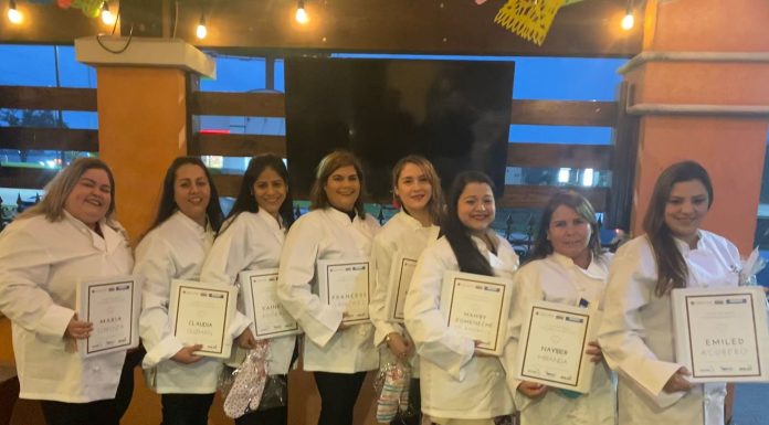 Culinary students holding their completion certificates