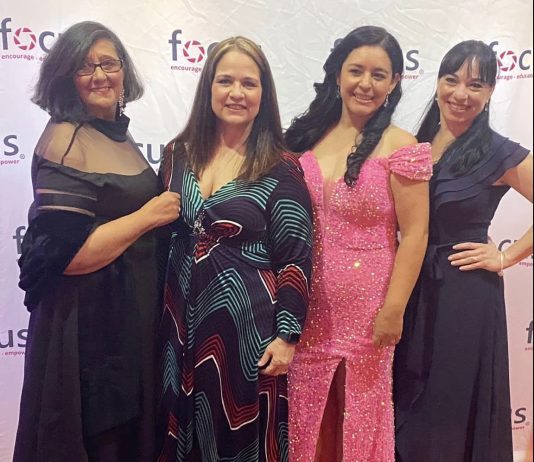 four women in formal gowns