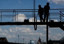 construction workers standing on a scafolding