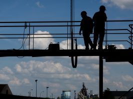construction workers standing on a scafolding