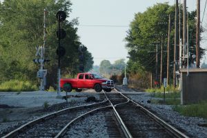 Truck driving over train tracks