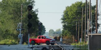 Truck driving over train tracks