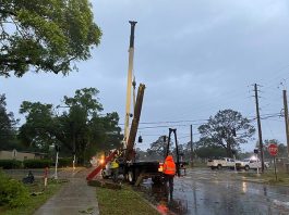 Crane lifting a street post