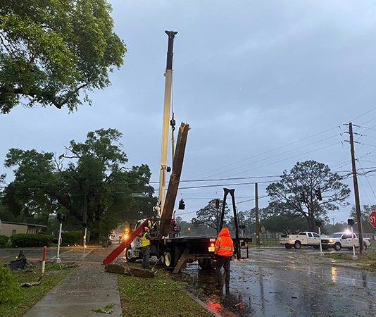 Crane lifting a street post