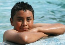 child at the edge of a swimming pool