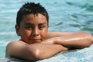 child at the edge of a swimming pool