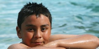 child at the edge of a swimming pool