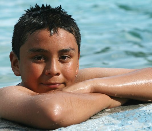 child at the edge of a swimming pool