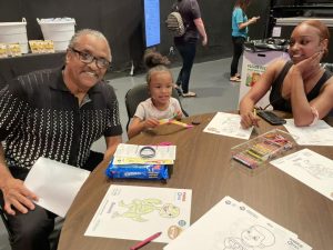 Family siting at a table coloring