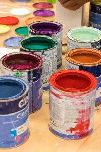 Multiple cans of different colored paint