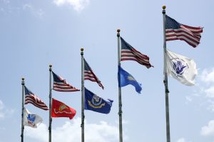 US and Military flags on poles