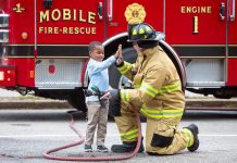 Firefighter and child high-fiving