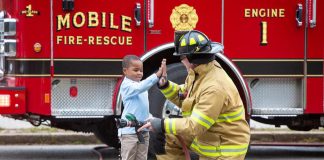 Firefighter and child high-fiving
