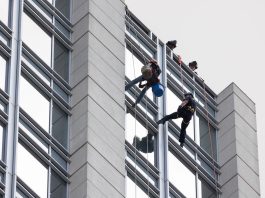 Window washers being rescued by fire department