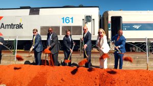 people shoveling dirt at groundbreaking