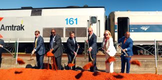 people shoveling dirt at groundbreaking