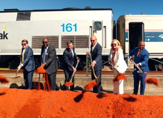 people shoveling dirt at groundbreaking