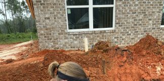 Person collecting a water sample from the ground